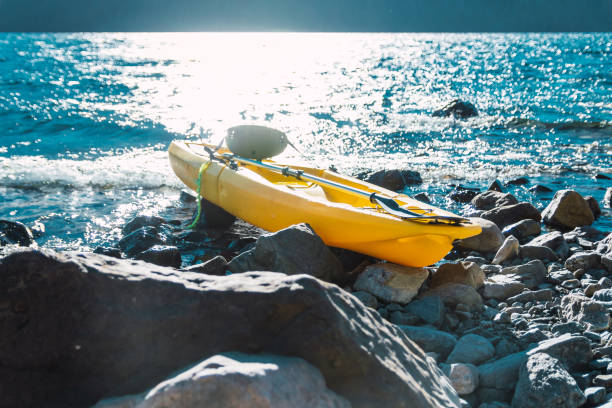 istock kayak in lake on stones 1313665330