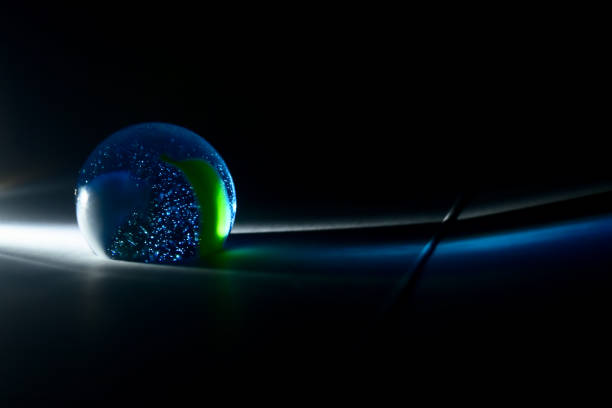 istock Blueish small marble balls with dark background photo 1313668546