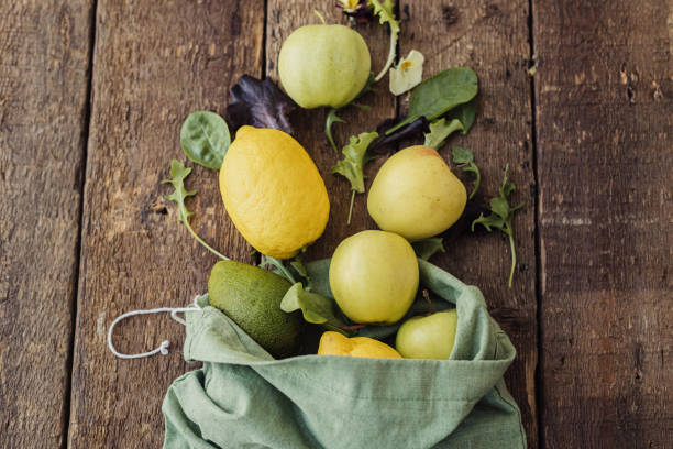 istock Eco friendly zero waste kitchen. Apples, lemon, avocado, salad leaves scattered from cotton bag 1313670478