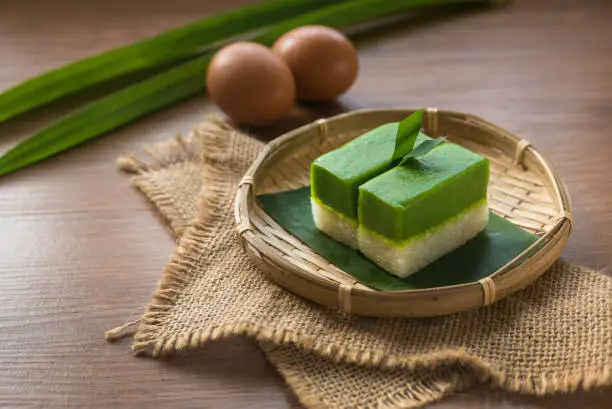 Photo of Selective focus of Kuih Seri Muka, traditional Malaysian two layered dessert with steamed glutinous rice forming the bottom half and a green custard layer made with pandan juice.