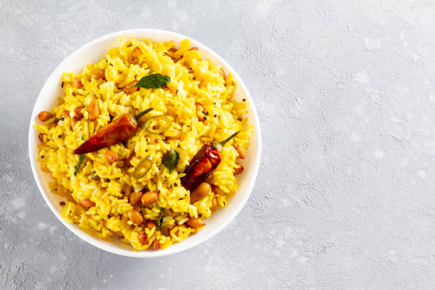 Yellow Rice, Turmeric Rice wih Lemon, Ginger and Fenugreek in a bowl, Indian Food. Top view with copy space. Yellow Rice, Turmeric Rice wih Lemon, Ginger and Fenugreek in a white bowl, Indian Food. Top view with copy space. LEMON stock pictures, royalty-free photos & images