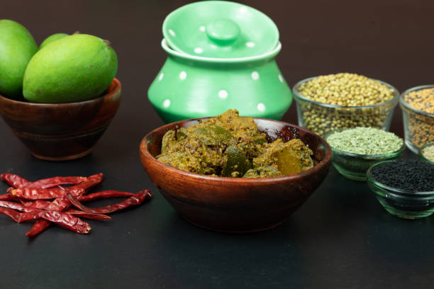 istock Mango Pickel or Homemade Mango Pickle in a wooden bowl, selective focus, isolated on black 1313674084