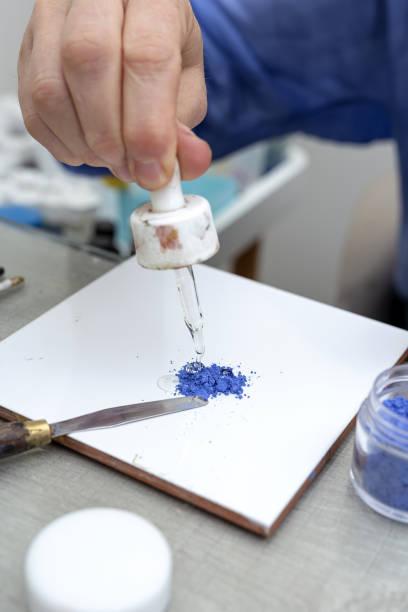 istock Unrecognizable woman hands working painting ceramic dishes 1313674145