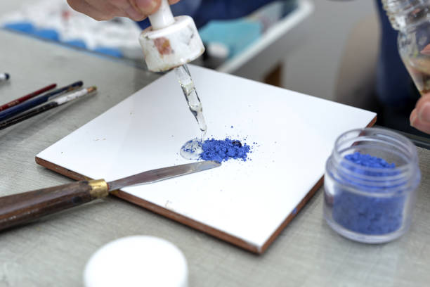istock Unrecognizable woman hands working painting ceramic dishes 1313674154