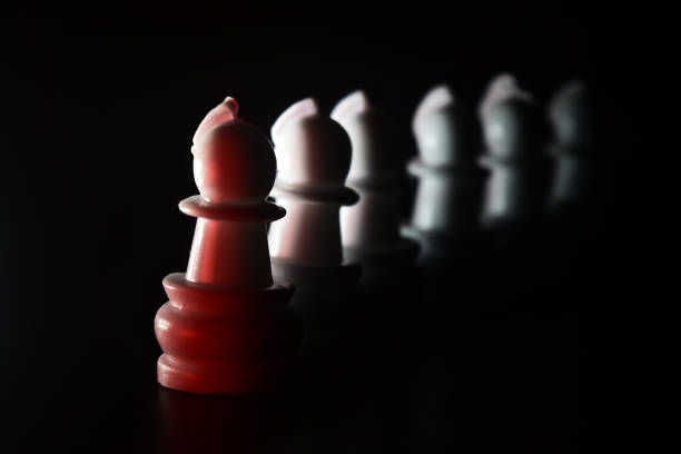 istock Traditional plastic chess pieces with dark background 1313675723