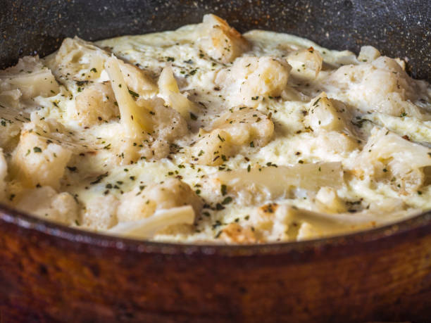 istock Cauliflower with eggs and milk in a pan close-up 1313675860