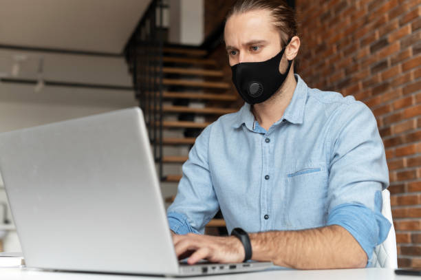 istock An office employee wearing mask indoor 1313675862