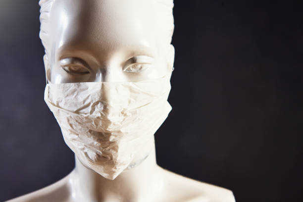 istock Store mannequin wears a protective surgical face mask, with copy space 1313677235