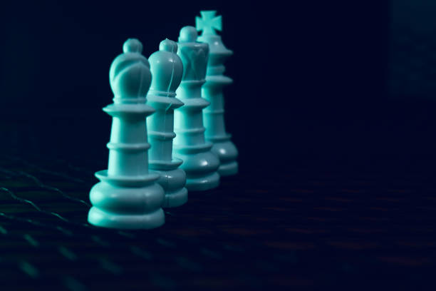 istock Multiple plastic chess pieces in a row unique photo 1313678066