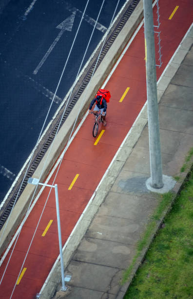 São Paulo, SP, Brazil - October 27, 2019: Cyclist riding down Paulista Avenue bike path on a sunny Sunday day