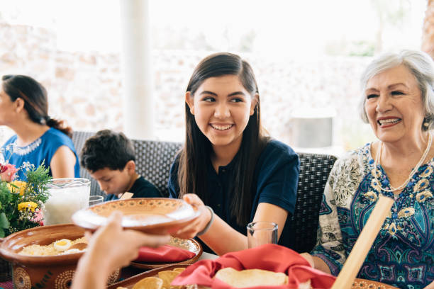 istock Multi-generation family eating together outdoors 1313678729