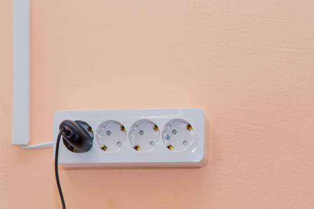istock An outlet with a plugged-in plug and wires going side by side in a box 1313681256