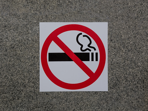 No smoking sign on granite wall close-up