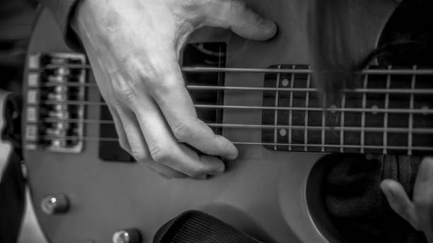 istock musician playing guitar black and white image, close up 1313686328