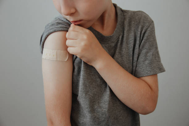 istock Vaccinated Boy Showing Arm After Covid-19 Vaccine Injection 1313688250