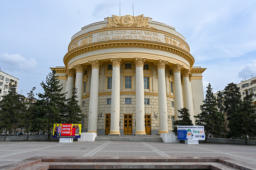 Volgograd, Russia - April 10, 2021: Palace of Culture of Trade Unions. Text reads Labour in USSR is the matter of honour, glory, valour and heroism. Caption: \