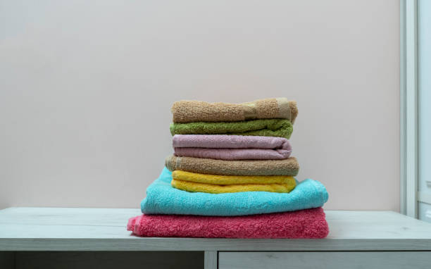 istock stack of new clean fresh color towels textile on the shelf in laundry 1313689716