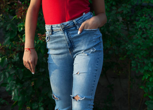 istock Young girl's legs in blue torn jeans. 1313691163