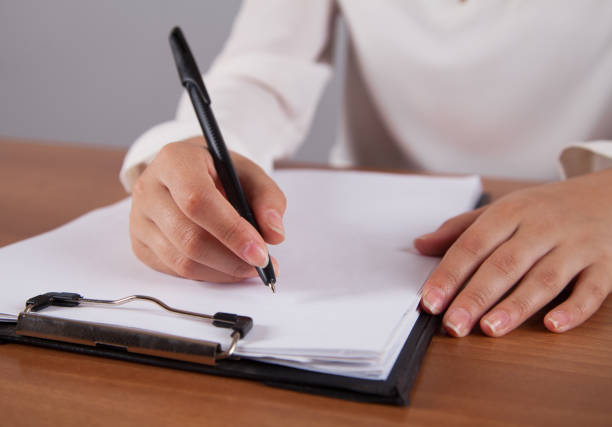 istock Businesswoman writes on documents. In the office. 1313691171