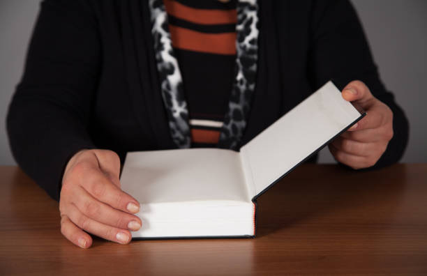 istock Woman is reading a bible. Wooden table. 1313691259