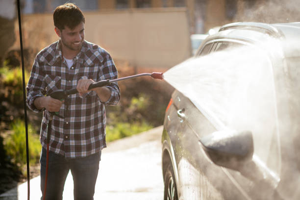 istock Man washing car in car wash 1313691296