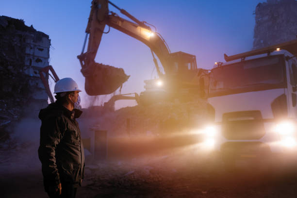 Engineer working late at night on the construction site stock photo