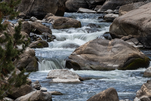 Rocky Mountain river water cascading over boulders of 11 mile canyon recreation area near Lake George, Colorado in western USA.