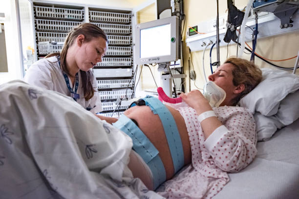 istock Pregnant woman preparing for delivery, getting help from nurse. 1313696142