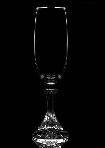 istock An empty Champagne Flute in silhouette with reflection, isolated on black. 1313697584