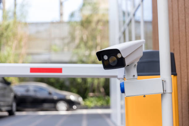 istock Security CCTV camera surveillance system outdoor of carpark. A blurred night city scape background. Modern CCTV camera on a wall. Equipment system service for safety life or asset. 1313698757