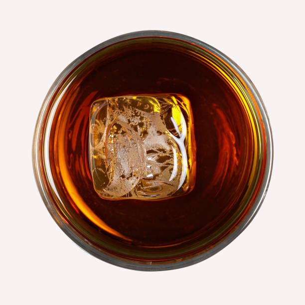 glass of bourbon with ice, isolated on white background