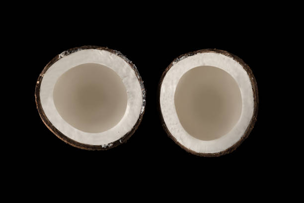 istock Coconut divided into two equal parts, view from the top, on a black background, isolated 1313702713
