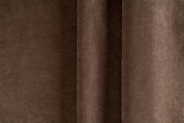 istock curtain fabric canvas light brown, folded in folds, background 1313704179