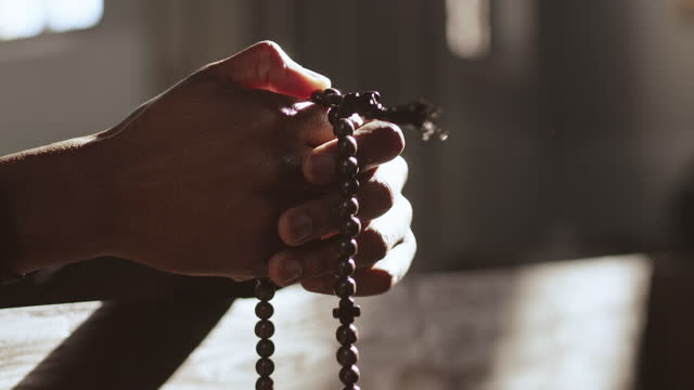 Hands of Unrecognizable African-American Man with Rosary Beads