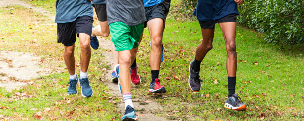 istock Group of boys running on a dirt path in a park 1313704785