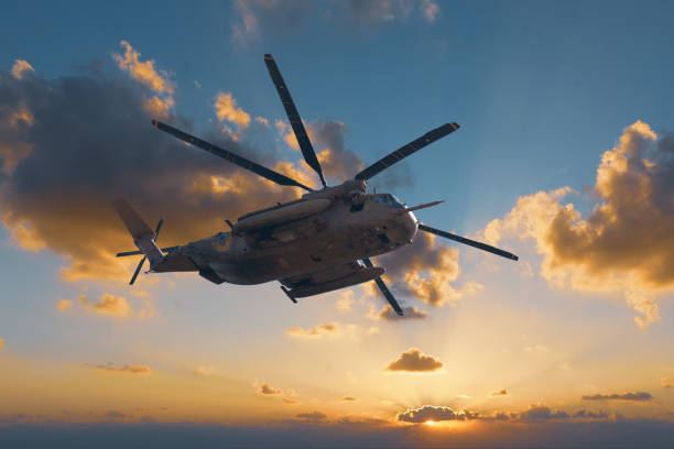 istock military helicopter at sunset background 1313704810