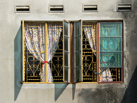 Retro style window frames of an Heritage architectural building located in Malacca State, Malaysia.