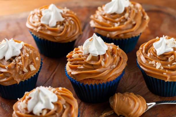 istock Tasty cupcakes with dulce de leche on a wooden table. 1313710108