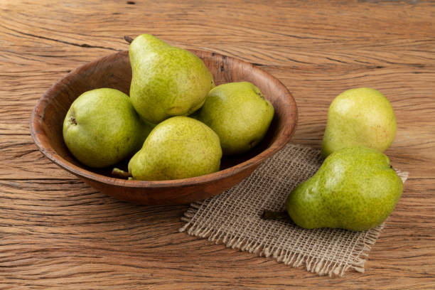 istock Green pears in a bowl over wooden table 1313711223