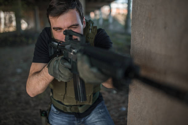 istock Professional military operator aiming with rifle in war zone 1313711979
