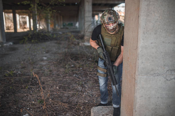 istock Confident military operator holding rifle in patrol in war zone 1313712001