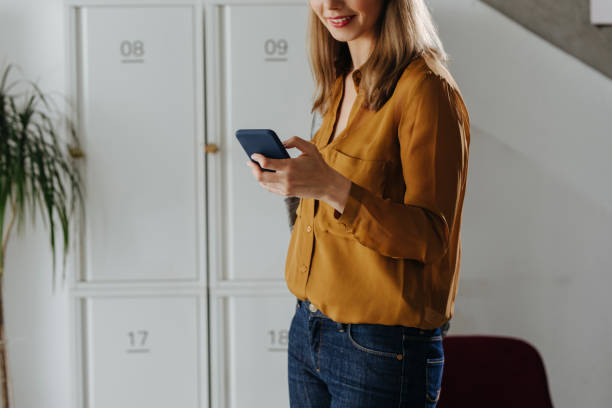 istock Anonymous Businesswoman Using her Smartphone at Work 1313726661