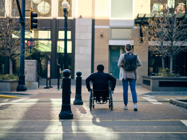 istock Disabled Man and a Friend in a Downtown Area 1313728185