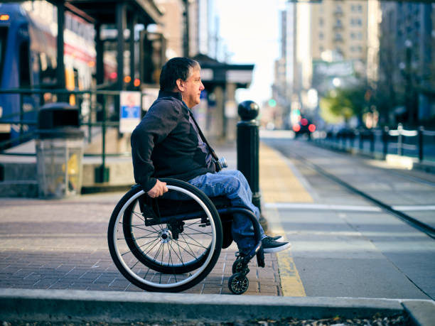 istock Disabled Man in a Wheelchair Waiting at a Train Station 1313728196