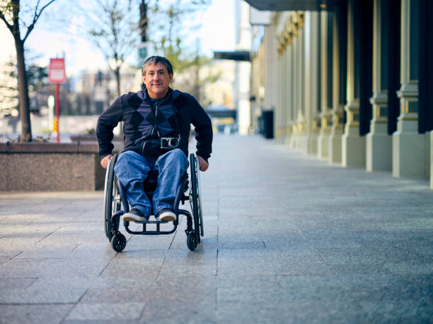 Man with wheelchair on the beach watching the view