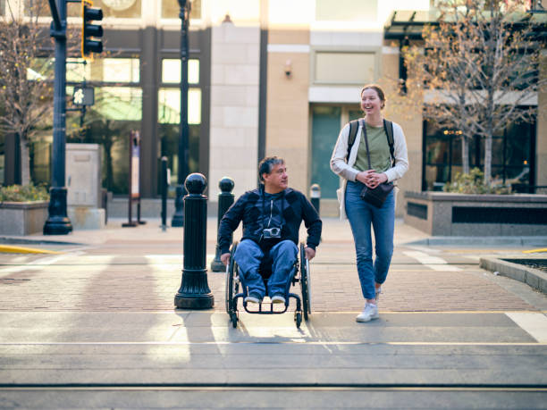 istock Disabled Man and a Friend in a Downtown Area 1313728292