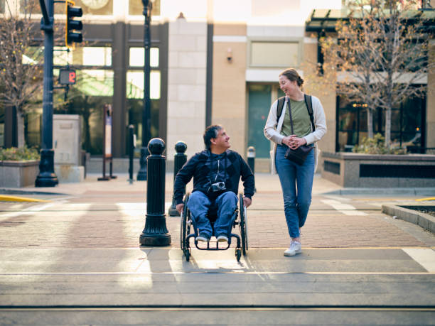 istock Disabled Man and a Friend in a Downtown Area 1313728340