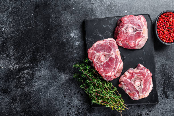 Raw lamb neck meat on a marble board.
Black background. Top view. Copy space Raw lamb neck meat on a marble board.
Black background. Top view. Copy space. lamb meat stock pictures, royalty-free photos & images