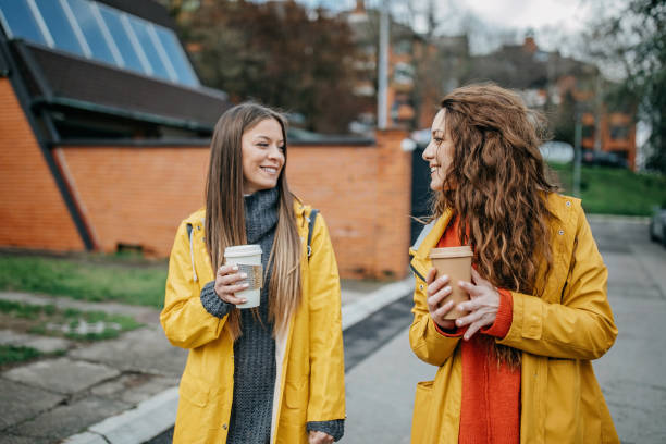 istock Two friends walking and drinking coffee 1313730876