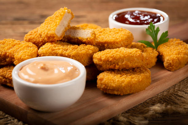 Fried chicken nuggets with ketchp and rose sauce. Fried chicken nuggets with ketchp and rose sauce. nugget photos stock pictures, royalty-free photos & images